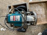 a machine that is sitting on the ground next to a box