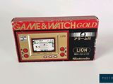 a game and watch gold box with a game on it
