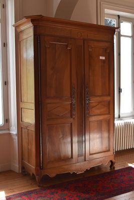 an image of a living room with a large wooden armoire