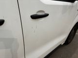 a white car parked in a parking lot next to a building