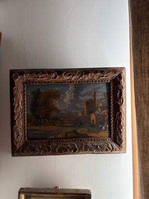 a clock on the wall next to a painting on the wall