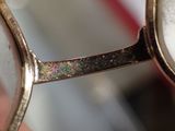 a close up of a person holding a pair of glasses
