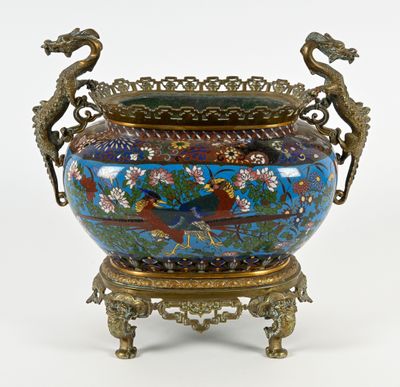 a large vase with two birds on it on a stand