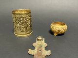 three different types of brass items are displayed on a table