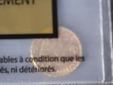 a picture of a gold coin with a label on it