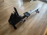 a rowing machine sitting on the floor in the living room
