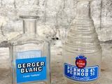 two bottles of alcohol sitting next to each other on the ground