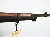 an old gun with a tag hanging from it ' s side