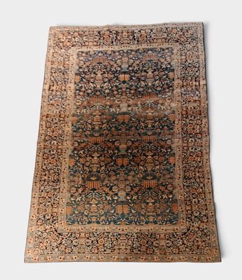 an antique persian rug with a blue and brown design