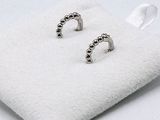 silver plated stud earrings with black beads on a white cloth