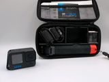 a black case with a camera and a charger in it