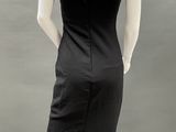 an image of a mannequin wearing a black dress with a v - neck