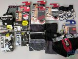 a lot of men ' s underwear that are on the table