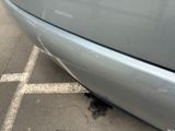 a close up of a car ' s bumper with a hole in it