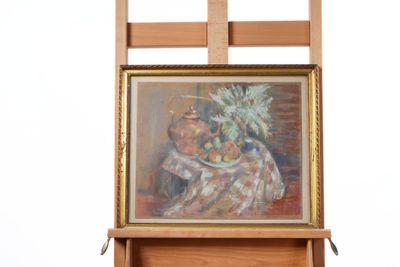 a picture of a painting on a easel next to a chair