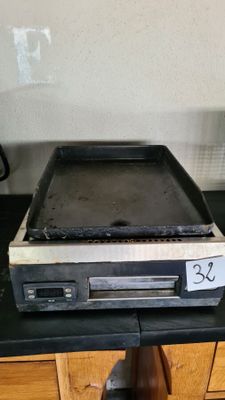 a stove top with a pan on top of it on a kitchen counter