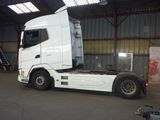a large white truck parked in a garage
