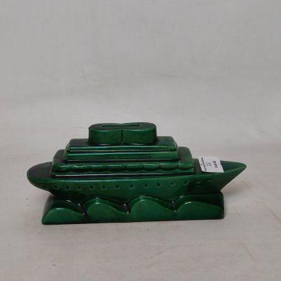 a green boat that is sitting on top of a table