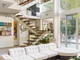 a living room with a couch, coffee table, and stairs