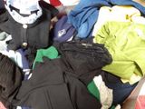 a pile of clothes that is sitting in a suitcase