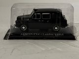 a black truck in a glass case on a white surface