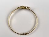 a close up of a gold bracelet with a snake on it