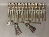 a lot of silver spoons and spoon spoons on the table
