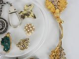 a lot of jewelry on a plate on a table