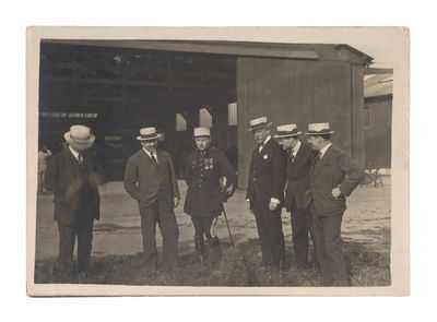 several men in suits and hats are standing in front of a building
