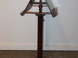 a metal object on a wooden stand in a room