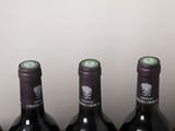 four bottles of wine are lined up on a table
