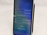 a phone that is sitting on a stand on a table