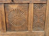 an old wooden chest with carvings on it