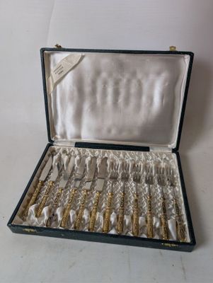 a black case with silverware in it on a white surface