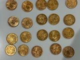 a lot of gold coins that are on the table