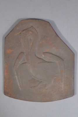 a stone plaque with a woman sitting on a chair