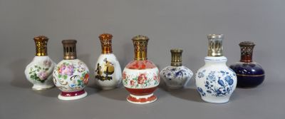 Plusieurs vases aux motifs variés sont alignés sur une surface grise