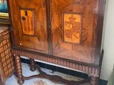 a wooden cabinet that has a door on top of it