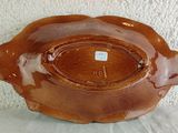 a brown bowl sitting on top of a white table