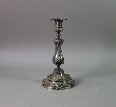 a silver candle holder on a table with a white background