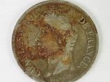 an old silver coin with a picture of a man ' s face on it