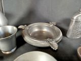 a silver plate and a silver cup on a table