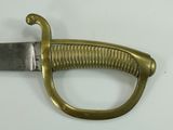 a close up of a sword on a white surface