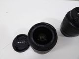 a camera lens sitting next to a cup on a table