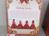 a box of holiday barbie dolls sitting on top of a table