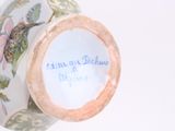 a vase with a writing on it sitting on a table