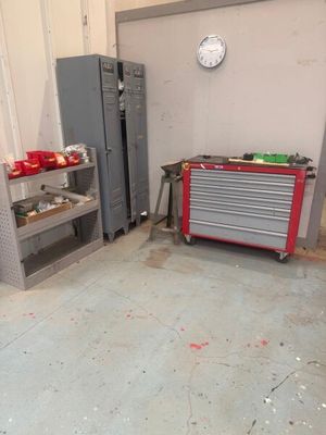 an image of a garage with a lot of tools on the floor
