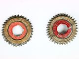 paire d'engrenages vintage en métal avec des finitions rouges et dorées