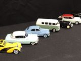 several toy cars are lined up in a row on a black surface