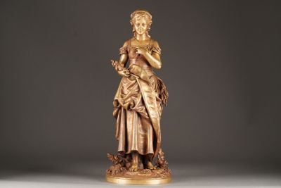 statue of a woman holding a flower in her right hand